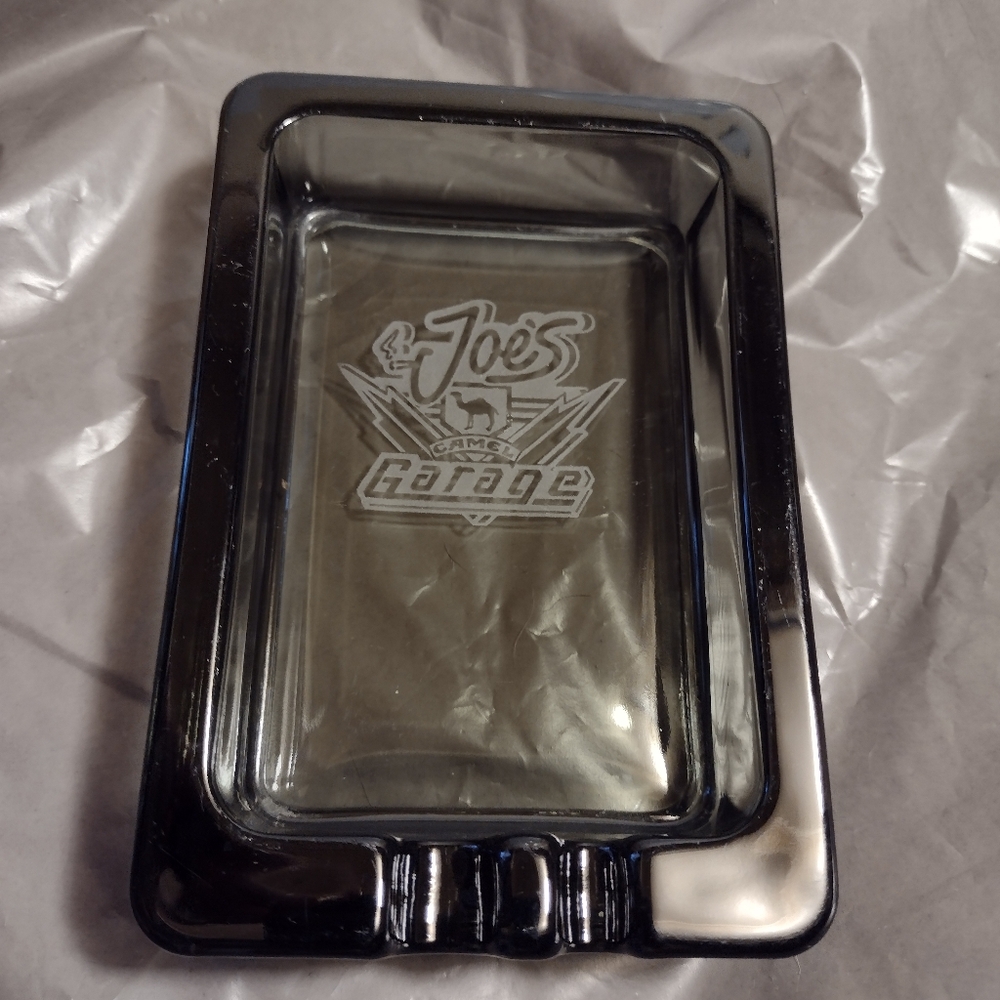 Vintage Smokey Grey Glass Camel Cigarette Joe's Garage Ashtray Etched Unused